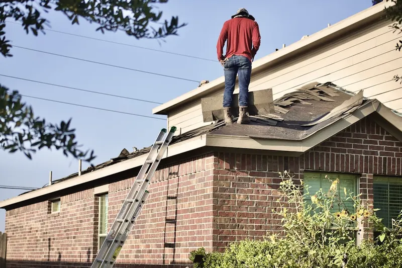 Professional roofer working on a residential roof in Aubrey